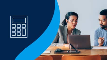 An accountant pointing to her laptop to show an accounting degree major information about the career field.