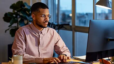 A business professional researching the best MBA programs.