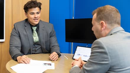 Kevin Bucardo, MBA with a concentration in Finance graduate from SNHU, engaged at work.