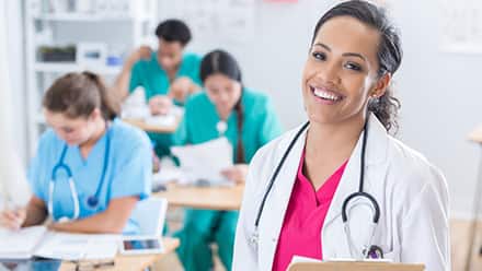 A person with a stethoscope and clipboard who gets to be both a nurse and a teacher as a nurse educator.