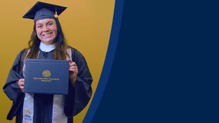 Paola Andrea Gaona Salamanca, a 2026 SNHU graduate who earned her bachelor's in business administration wearing her cap and gown and holding her diploma in front of a yellow background.