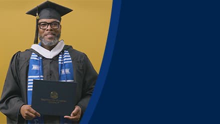 Tyrone R. Turner-Perry, an SNHU graduate with a bachelor's in communication, dressed in his graduation cap and gown.