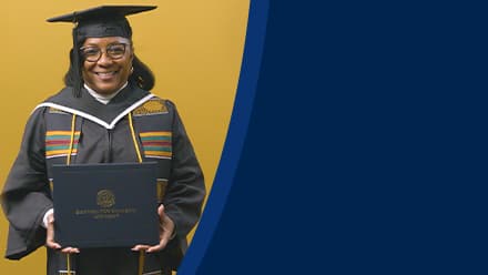 Valerie Craig, a 2025 graduate from SNHU with an associate degree in liberal arts, dressed in a cap and gown and holding her diploma.