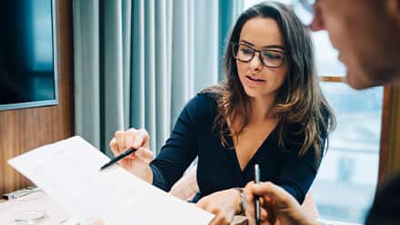 A woman showing someone a look into what a bookkeeper does