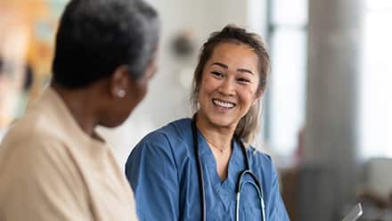 A nurse smiles and explains to another nurse what is an MSN degree.