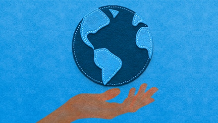 Graphic treatment of a hand holding the earth on a blue background