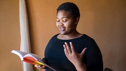 A woman reading poetry to celebrate national poetry month and demonstrate why poetry is important