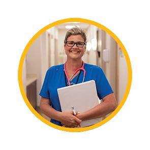 SNHU Student in nursing scrubs with a notebook