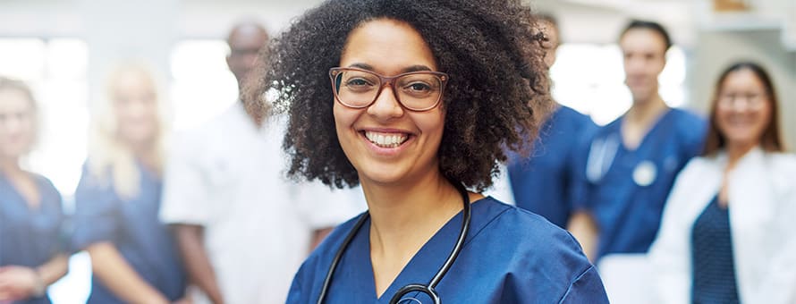 A nurse with a stethoscope surrounded by six other healthcare professionals.