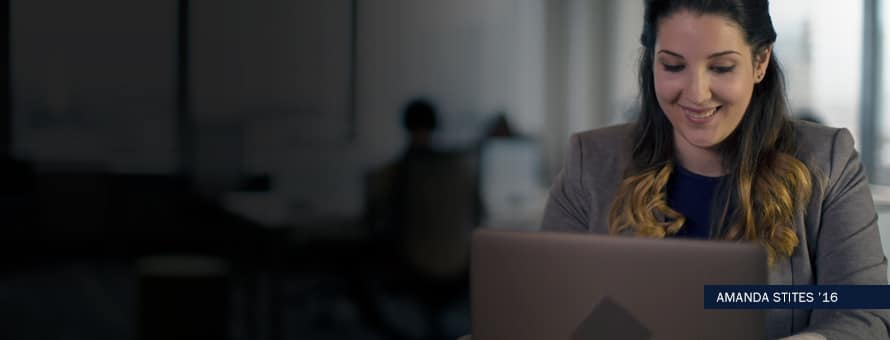 Woman sitting and typing on a laptop, with the text "Amanda Stites '16"