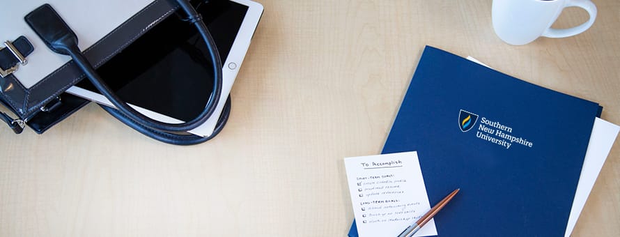 A blue SNHU folder and a pad of paper with a to-do list nearly complete