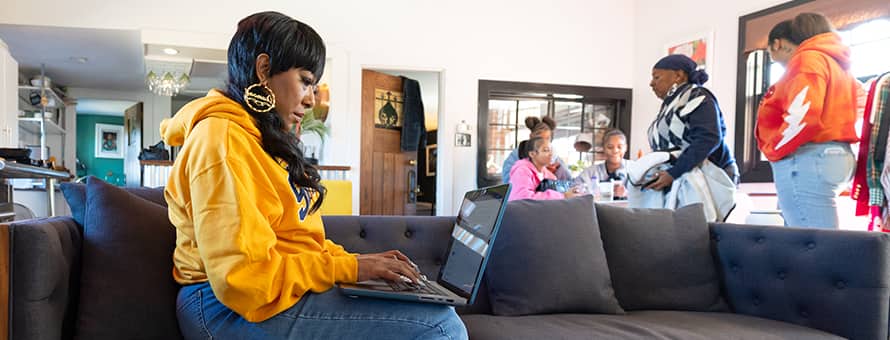 Remy Twine '25, who has an associate degree in marketing from SNHU, working on her degree at home.