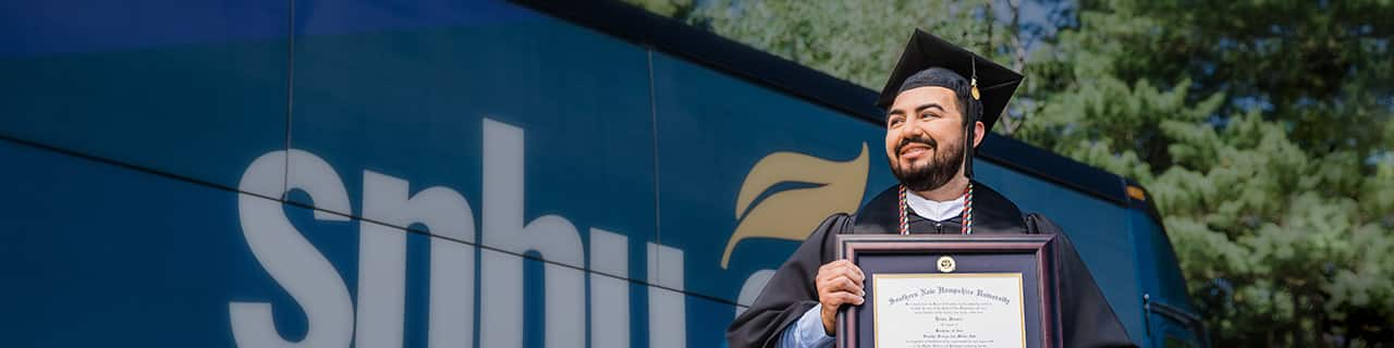 SNHU Graduate Jesús in his regalia cap and gown