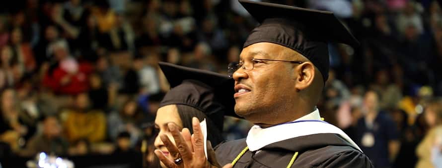 Father Michael Glenn attending SNHU spring Commencement 2023