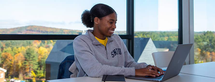 A SNHU student working on her laptop