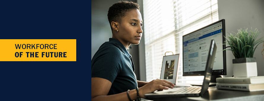A woman looks at a laptop considering the future of work