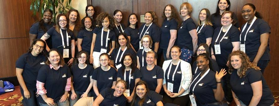 Group photo of the two dozen women in tech degree programs at SNHU who visited the Grace Hopper Celebration.