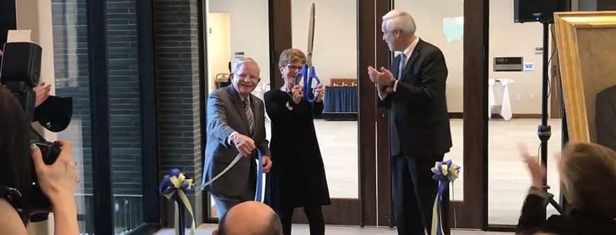 Dr. Richard A. Gustafson and his wife cutting the ribbon for the Gustafson Center grand opening