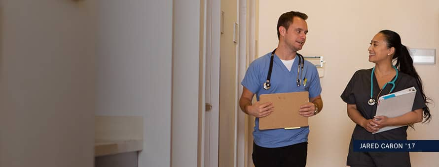 Jared Caron walking down a hall and talking to a colleague with text Jared Caron '17