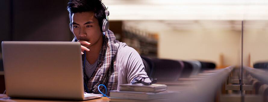 Man sitting at laptop planning how to go back to school