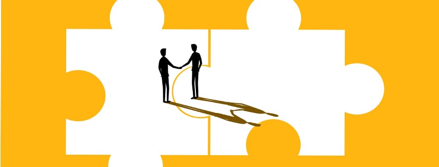 Two silhouettes shaking hands on puzzle pieces to represent negotiation.