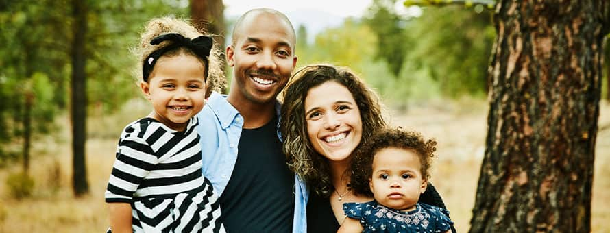 A couple using strength-based parenting techniques with their two young children.