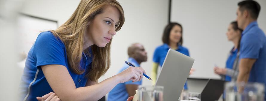A student looks at her laptop and writing about why health education is important