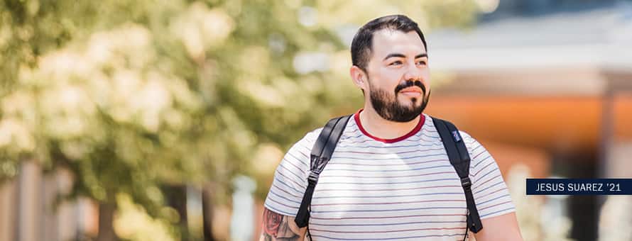 Jesus Suarez, an online graphic design degree student, walks around campus at SNHU.