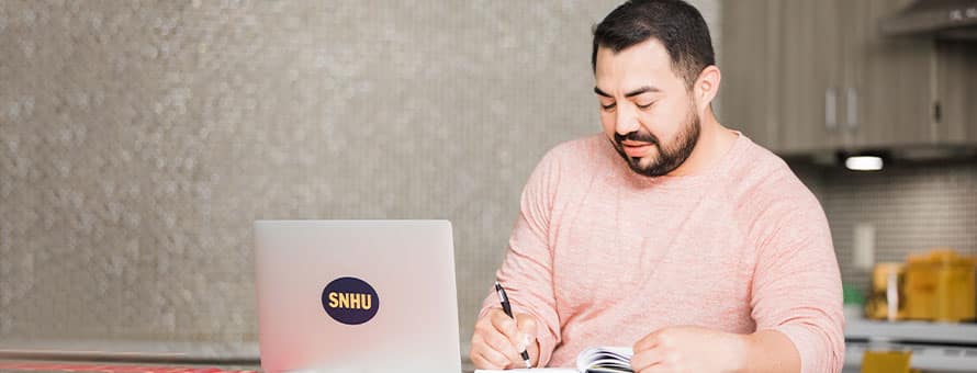 An SNHU student working on their laptop
