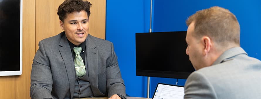 Kevin Bucardo, MBA with a concentration in Finance graduate from SNHU, engaged at work.