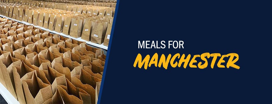 Meal packs to be distributed to students and their families during the pandemic and the text Meals for Manchester