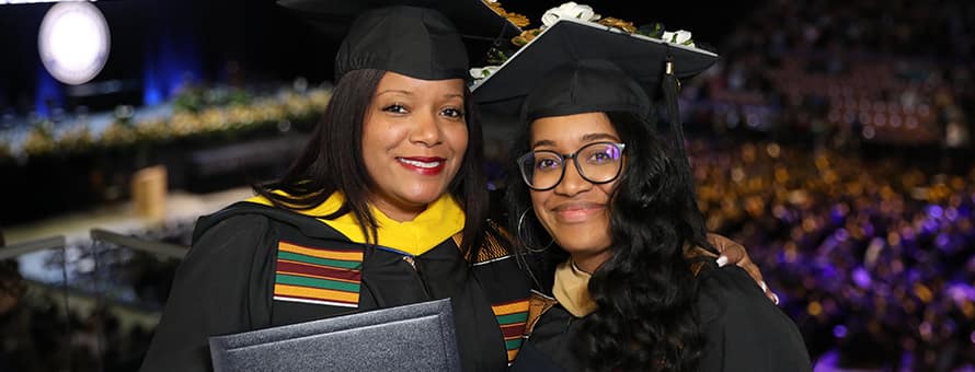 Mother and daughter Kim Medina and Chelsea Vega-Mitchell celebrating at Commencement