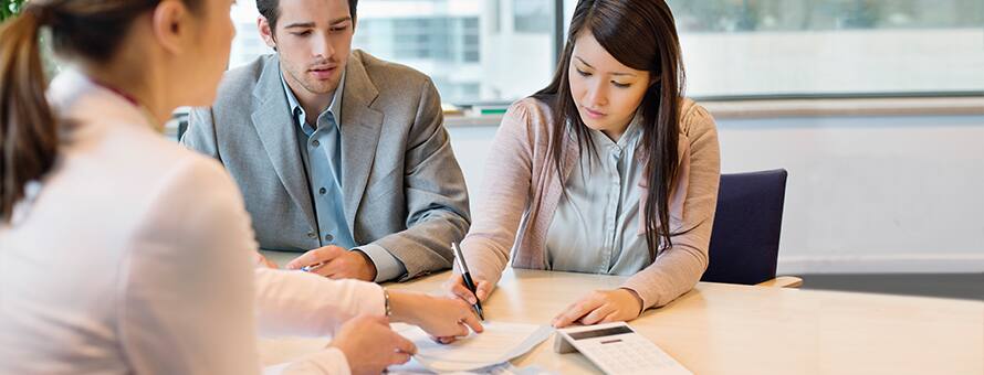 Three accountants with their masters degrees working on a project 