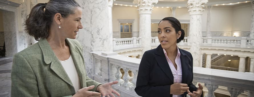 Two professionals discussing what you can do with a master’s in criminal justice