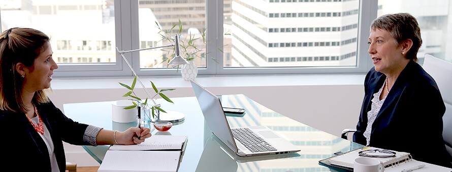 Two people having a meeting at a desk