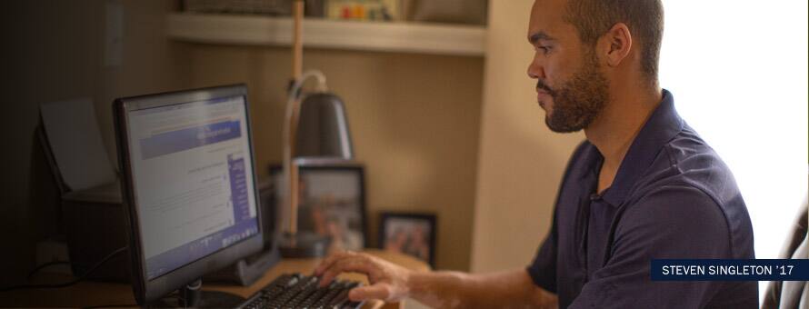Steven Singleton working on his computer with text "Steven Singleton '17"