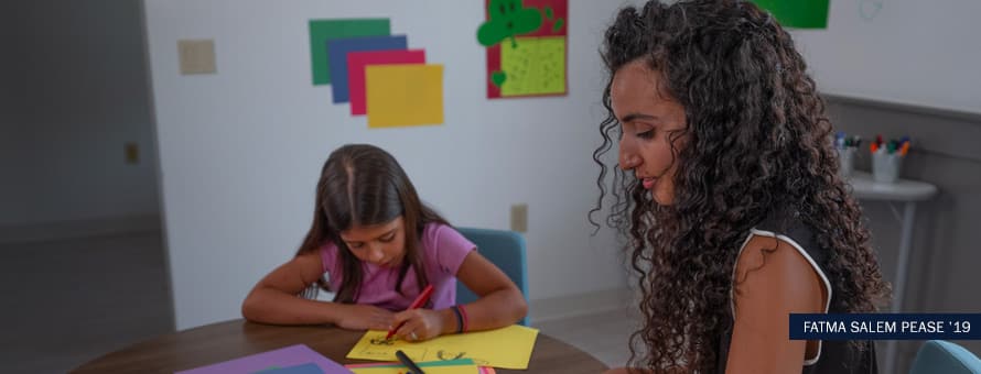 Child psychologist working with child with text "Fatma Salem Pease '19"