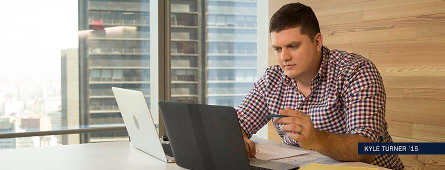 Online math degree student in plaid shirt performs calculations from laptop. with text: Kyle Turner '15