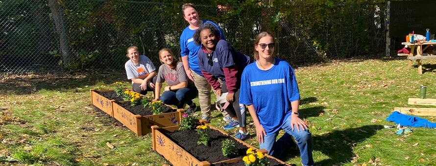 Students working in planter boxes in new outdoor classroom