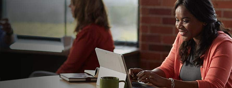 Woman sitting at table with her computer