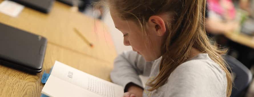 An elementary student reading