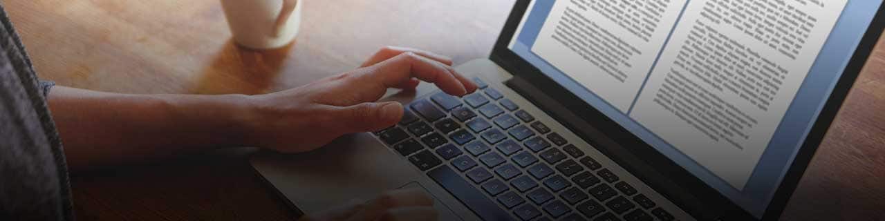 A person types on a laptop.