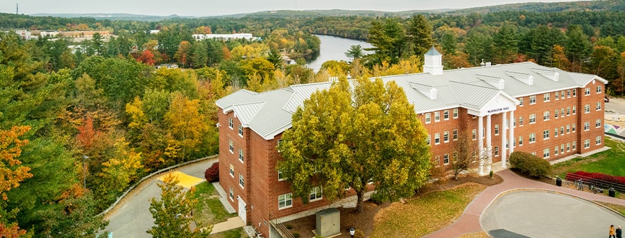Washington Hall on Southern New Hampshire University’s Manchester campus, surrounded by trees.