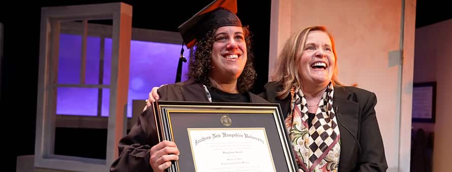SNHU graduate Stephanie Gould holding her diploma with SNHU's executive vice president and university provost, Lisa Marsh Ryerson