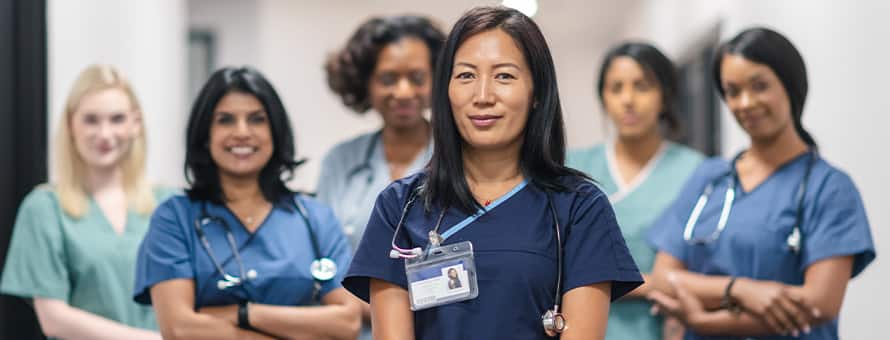 6 nurse leaders wearing medical scrubs and stethoscopes. 