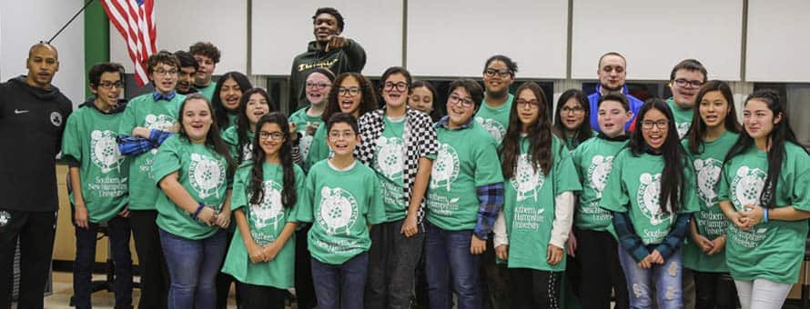 Dana Barros and Robert Williams join students unveiling a new technology lab.