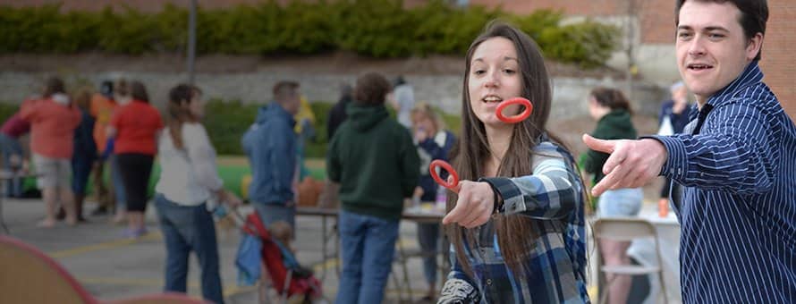 Students playing a ring toss game