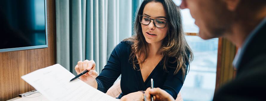 A woman showing someone a look into what a bookkeeper does