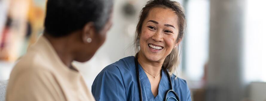 A nurse smiles and explains to another nurse what is an MSN degree