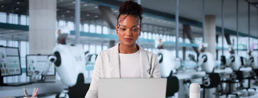 A woman working in a robotics lab, representing automation and AI replacing jobs in the workforce.